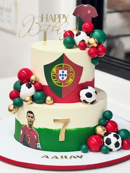 This Ronaldo-themed football cake was inspired by Portugal's colors and the legendary number 7. It's a two-tiered masterpiece for a little champ's special day.