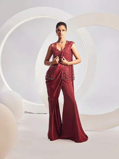 Our NAIDA Sharara Saree Set is an instant head-turner. It features an embellished blouse and sharara saree, with an extra layer of grandeur from a heavily embellished jacket.