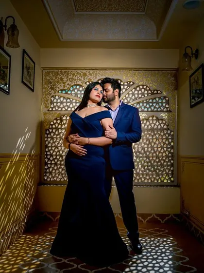 A stunning pre-wedding portrait using dramatic lighting from a jali window to create beautiful patterns of light and shadow.