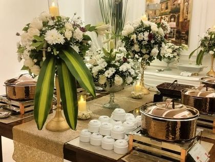 Another view of the anniversary setup, highlighting the beautiful bouquets and candle arrangements that complement the food.
