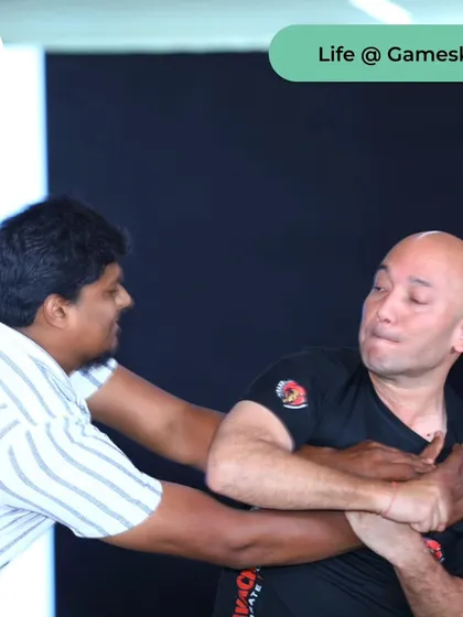Demonstrating a defense against a grab from behind during the Gameskraft event.