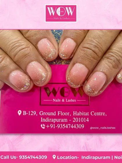 A soft and pretty look featuring a sheer pink base with a delicate silver glitter ombré at the tips. This is a perfect choice for a subtle touch of sparkle.