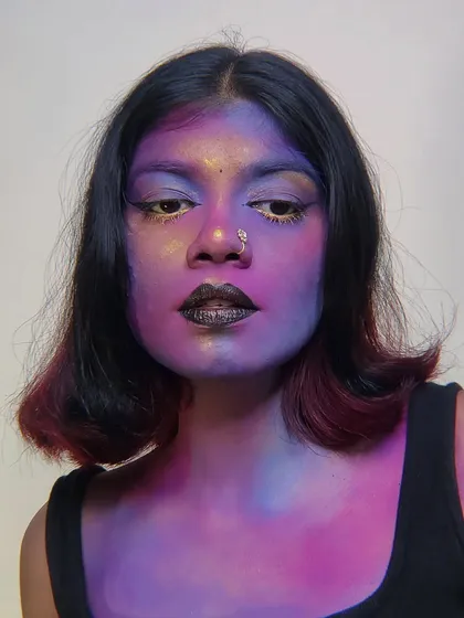 A galaxy-inspired face and body paint look I did on myself. I blended shades of purple, pink, and blue to create a nebula effect on the skin.