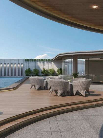 Another view of the rooftop pool and deck of the wave-inspired office. The curved forms of the architecture are carried through to the landscaping and furniture, creating a cohesive and fluid design.