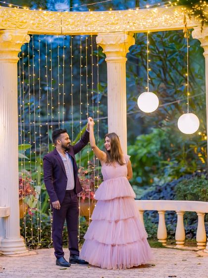 A couple dancing under a canopy of lights, a perfect shot to capture movement and romance during a night shoot.