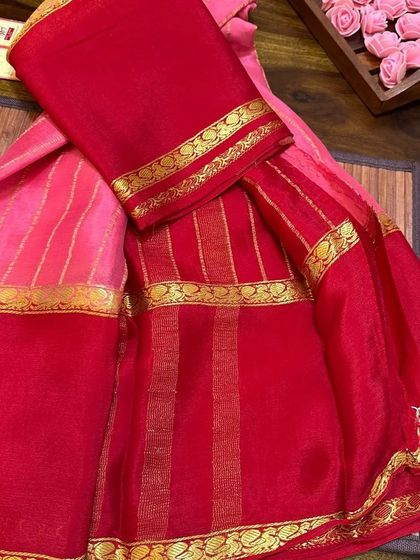The pink and red wrinkle crepe saree, showing the beautiful drape of the fabric.