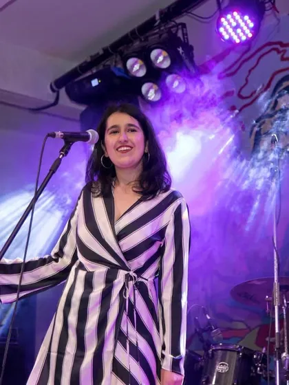 Another shot from our gig at a club in Pune. The colorful murals in the background added to the vibrant energy of the night.