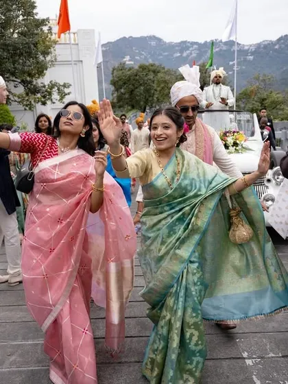 The baraat procession making its way through the beautiful mountain venue, full of dance and energy.