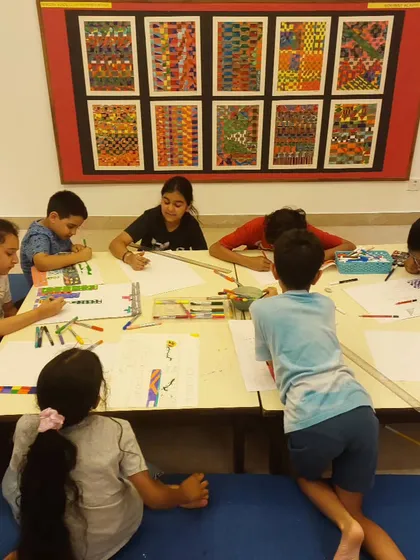 Serious drawing in progress! Here, my 8 to 15-year-old students are working on sketches for a 3D city project.