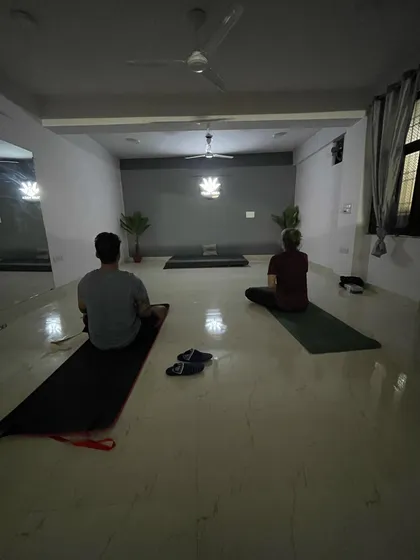 A view of my evening batch, where students are seated in a meditative posture to begin or end their practice. The dim lighting helps in turning the focus inward.