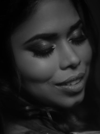 A dreamy black and white portrait. This artistic shot focuses on the beautiful eye makeup and the bride's serene expression.