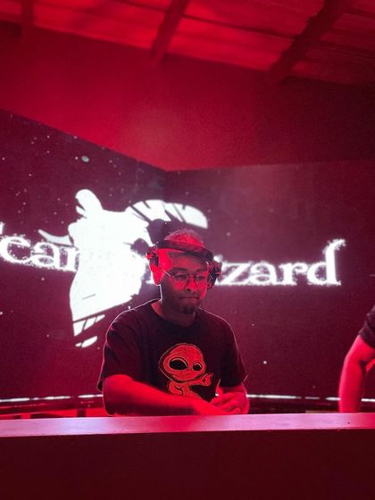 Behind the decks with my logo on the big screen. This was for a techno event in Bangalore, where I played a selection of my favorite dark and minimal tracks.