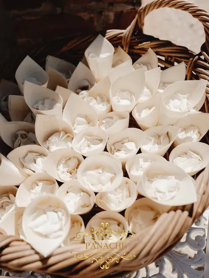 A basket of white rose petals, ready for guests to shower the happy couple.