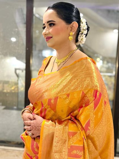 A side profile showing the beautiful gajra bun and the glow on her skin. This is a perfect look for any wedding guest.