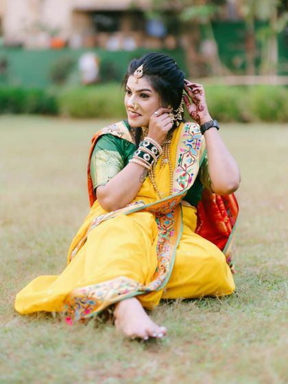 An elegant yellow Nauvari, perfect for a Haldi ceremony or any daytime festive event. The green blouse provides a beautiful contrast.