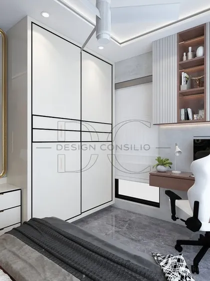A bedroom designed for a gamer, featuring a dedicated study and gaming desk with a comfortable chair. The wardrobe has a clean, modern design with a full-length mirror integrated into the dresser unit.