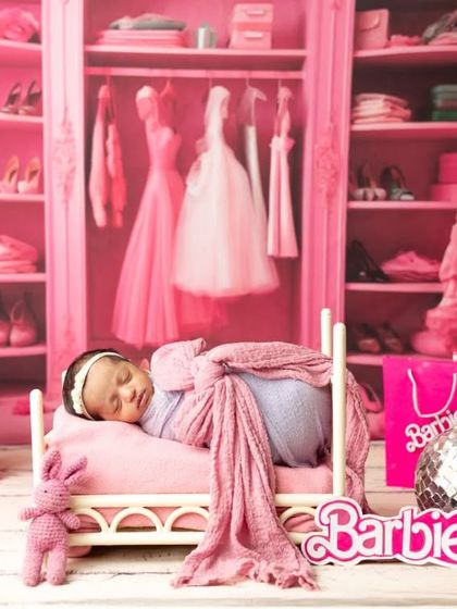 Even the tiniest dolls can join the fun. This newborn is captured sleeping peacefully in a miniature bed within the Barbie dream world setup.