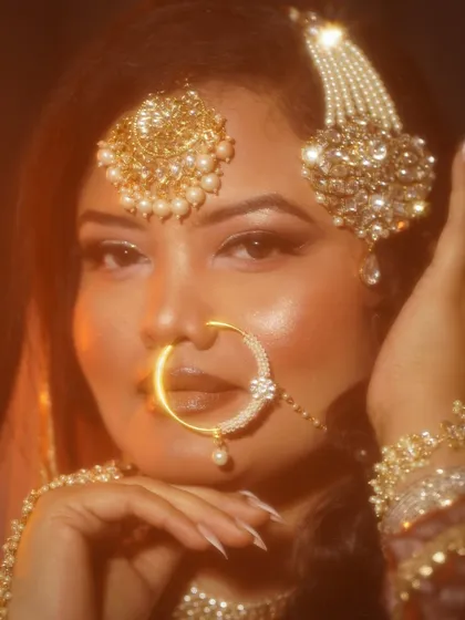 A direct portrait showcasing the flawless base and intricate details of the nath and maang tikka.