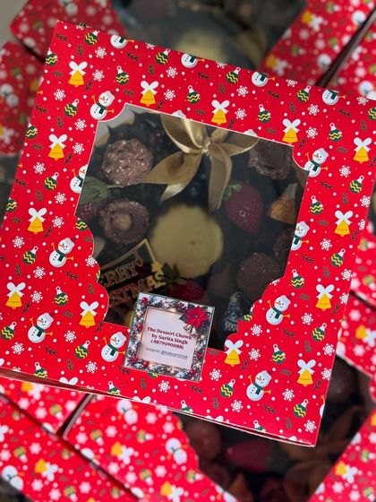 The festive packaging for my Christmas Brownie Wreath. The red snowman-themed box adds to the holiday spirit and makes it a perfect gift.