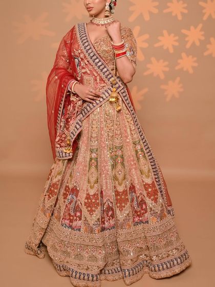 A full-length shot of our "Golden Era" lehenga, showcasing its grand flare and the beautiful way the different colored panels come together. This is a true statement piece for any bride.
