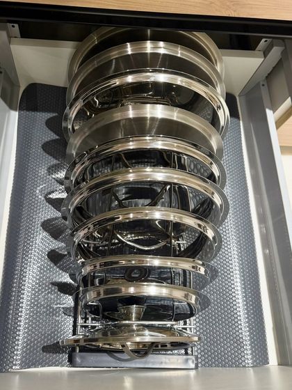 Another angle of the vertical pull-out rack for lids and plates. This innovative storage solution is a client favorite for its efficiency and sleek design.