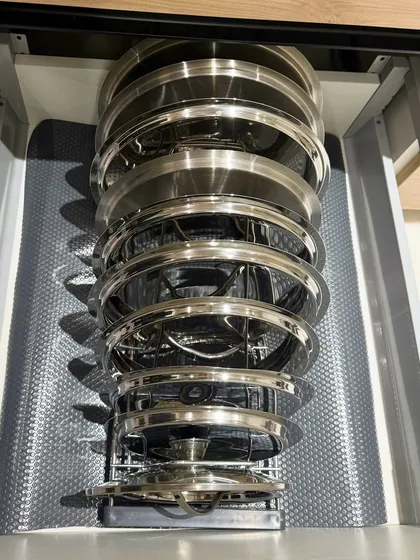 Another angle of the vertical pull-out rack for lids and plates. This innovative storage solution is a client favorite for its efficiency and sleek design.