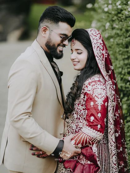 A close, tender portrait of the couple, their smiles and gentle touch conveying their deep affection.