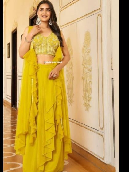 A smiling shot in the yellow ruffled Indowestern outfit, showing how it’s perfect for someone who wants a modern, comfortable, and stylish look.