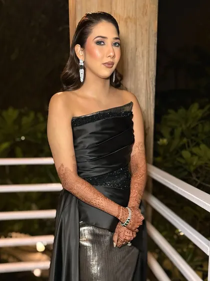 Another shot of this stunning cocktail look. The wet-look hair and glowing skin add to the high-fashion vibe of her outfit.
