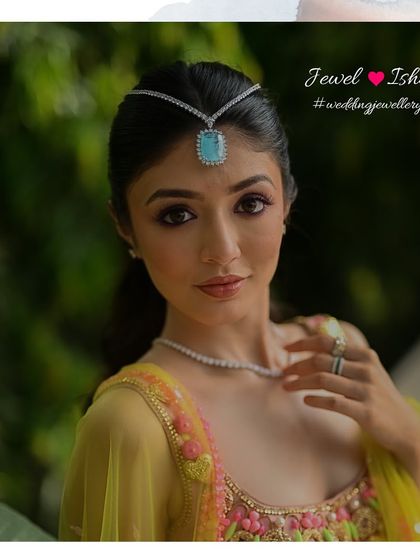 A close-up on the statement turquoise sheeshpatti. This is a great way to add a pop of colour and a modern twist to your hairstyle for a Mehendi or Haldi ceremony.