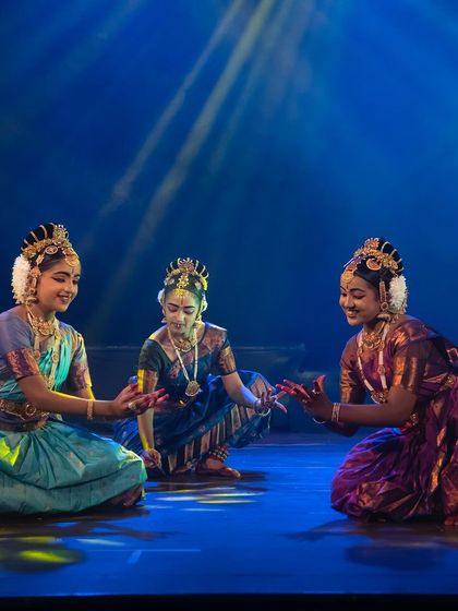 Three of our dancers sharing a lighthearted moment on stage during the "KRISHNA" production. The joy and camaraderie between the performers shine through in their dance.