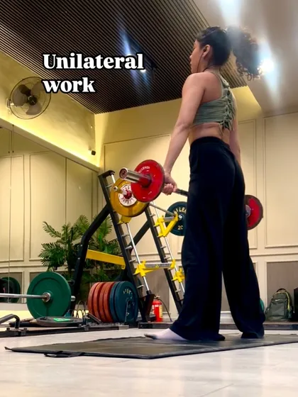 An image capturing the focus required for unilateral barbell work. It's all about balance and control.