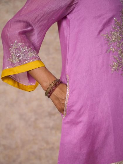 A close-up of a lilac kurta sleeve with delicate silver sequin embroidery, showcasing the fine craftsmanship.