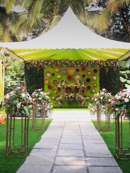 A wide shot of a naming ceremony at Farmhouse Collective. The bright green and yellow decor creates a lively and festive atmosphere.