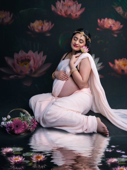 Serene bloom. This enchanting maternity shoot with a lotus theme captures the radiance and grace of an expectant mama in a dhoti-style saree.