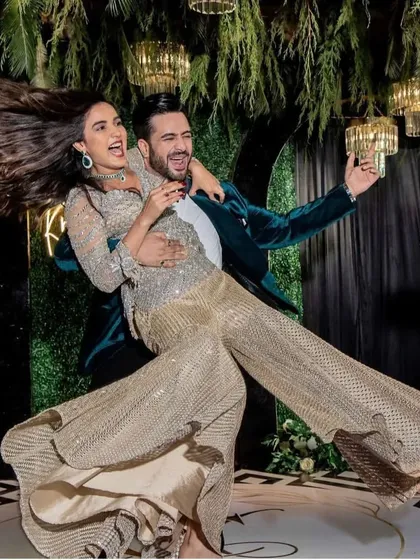 An iconic, fun-filled shot from Aly and Jasmin's performance. We choreograph dynamic poses that capture the energy of the dance and look amazing in photos.