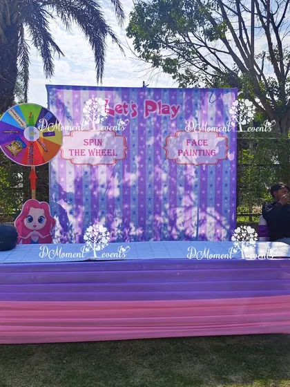 I set up dedicated activity stations like this one for face painting and a "Spin the Wheel" game, keeping the little ones happily occupied.
