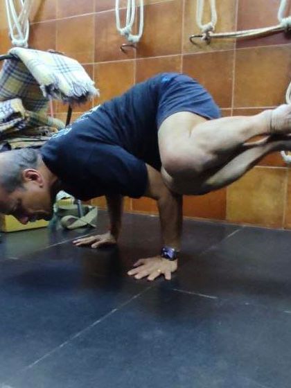 Another angle of Parsva Bakasana, showing the placement of the arms and the lift of the hips required to balance.