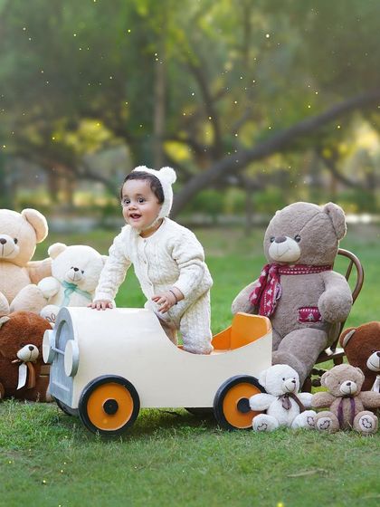 This little one is ready for an adventure in his teddy bear car. Outdoor sessions are great for capturing the curious and energetic spirit of toddlers.