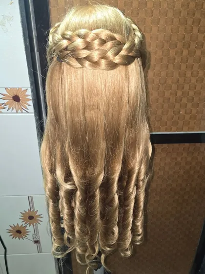 This is my signature braided crown, a style I absolutely love for its neatness and elegance. The braid acts like a natural headband, while the rest of the hair is styled into soft barrel curls, making it a versatile choice for parties and receptions.