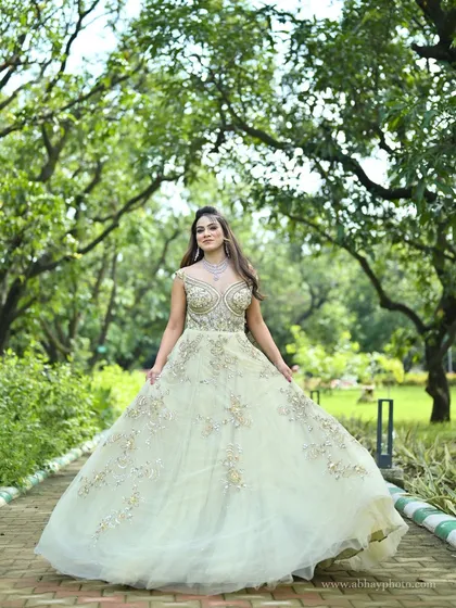 An elegant, flowing gown in a soft pastel green, detailed with delicate silver and gold embroidery. This is a perfect choice for a modern reception or engagement ceremony, offering a blend of tradition and contemporary style.