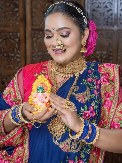 The combination of the embroidered saree, traditional jewelry, and festive spirit makes this look truly special.
