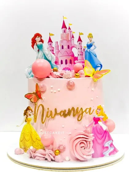 A pretty pink Disney princess cake, featuring a castle and four different princesses. The design is feminine and perfect for a royal celebration.
