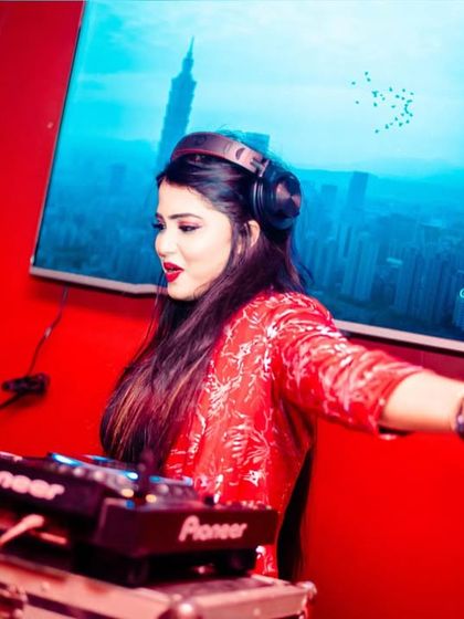 In the zone at Dazzling Gran Palacio, mixing tracks against a vibrant red backdrop.