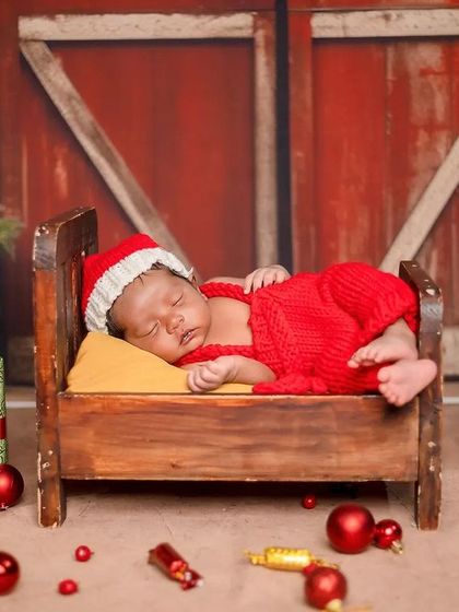 The entire Christmas-themed set is designed to create a warm and joyful atmosphere. The barn-style background and festive props make for a classic holiday photo.