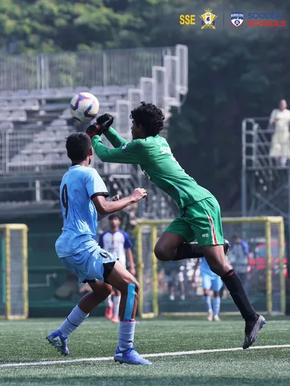 An aerial battle during a U17 match, with our goalkeeper confidently claiming the ball. This highlights the physical and mental strength we build in our players.