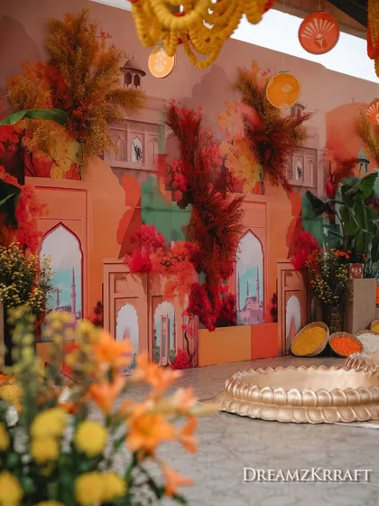 The main stage for the 'Turmeric & Zataar' Haldi, with a backdrop of painted palatial arches and vibrant florals. This shows how I blend artistic painting with 3D floral arrangements.