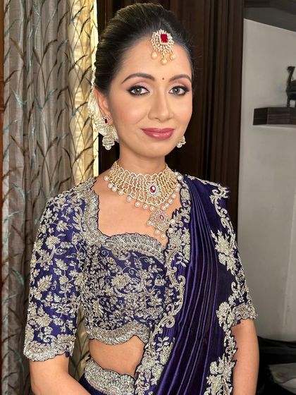 The full look, showcasing the stunning embroidered blouse and pleated saree.