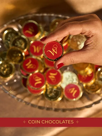 Custom coin chocolates with my brand's "W" monogram, adding a touch of personalized luxury to our festive hampers.