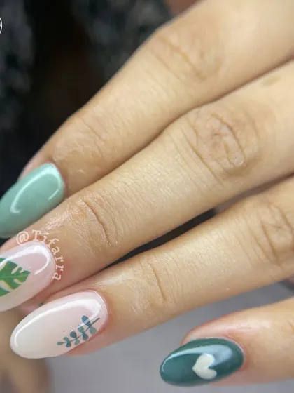 On my mind lately. Gel extensions with a mix of solid green nails and accent nails with tropical leaf decals.